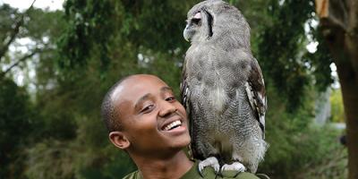 student Washington Wachira with a Verreaux's Eagle-owl