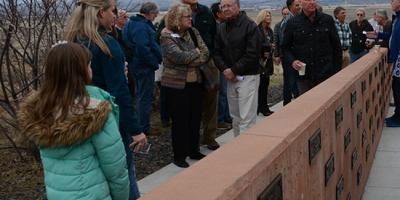 Rendezvous attendees in 2017 examine the markers recently added to the Wall of Remembrance